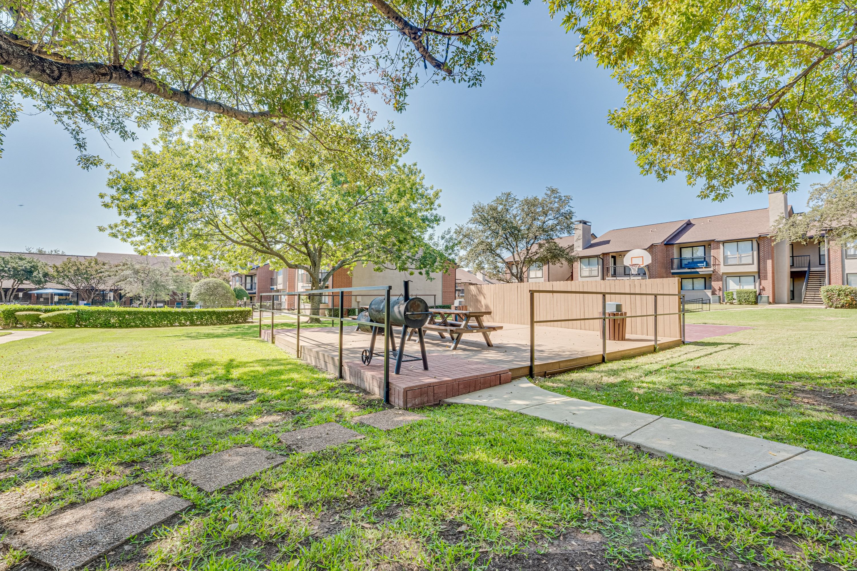 Wooden deck with picnic tables at Bardin Oaks Apartments, Arlington, TX